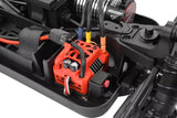 Close-up of a red Team Corally C-00180-1016 ESC Plate installed in an RC car chassis with connected wires and surrounding radio control parts.