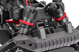 Close-up of black and red shock absorbers installed on an rc car chassis featuring Team Corally C-00180-658 Shock Cap Protector (2) for enhanced durability and protection.