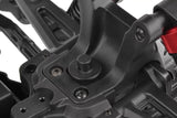 Close-up view of a black plastic RC car chassis component featuring the Team Corally C-00180-024 Body Post (2) installed, highlighting detailed mount points for body attachment.