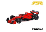 Team Saxo TS01946 1/10 F1 Body Shell (Clear) displayed in a red and black painted finish on a radio control F1 car model with detailed decals and aerodynamic design.