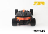 Front view of a black and orange Team Saxo TS01945 1/10 F1 Body Shell (Clear) designed for radio control cars, showing aerodynamic details and large rear tires.