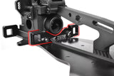 Close-up of Team Corally C-00180-141 Aluminum Suspension Arm Mount PRO Rear-Front installed on an RC car chassis, showcasing black anodized aluminum and precision machining for radio control parts.