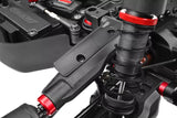 Close-up view of a black suspension arm with red anodized accents fitted on a radio control car, showcasing the Team Corally C-00180-915 Left and Right Winglets for HDA-3 Front Upper Arms.