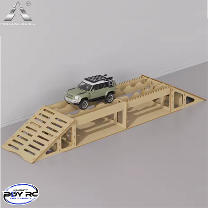 A wooden RC crawler obstacle course featuring ramps and a narrow single plank bridge with a small green off-road RC vehicle on top, designed as the Pincone Models Single Plank Bridge 1/24 1/18 RC Crawler Course.