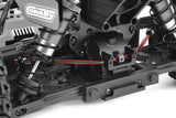 Close-up of the Team Corally C-00180-246 Rear Anti-Roll Bar 2.6mm installed on a radio control car chassis, showcasing the suspension and anti-roll bar assembly.