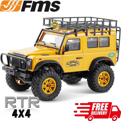 Detailed yellow FMS FCX24M Land Rover Defender 90 Camel Trophy 1/24 RTR radio control car with rugged tires, roof rack, and off-road design, ready to drive.