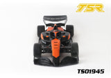 Team Saxo TS01945 1/10 F1 Body Shell (Clear) mounted on an RC F1 car chassis with black and orange detailing, showcasing a sleek aerodynamic design for radio control cars.