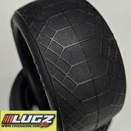 Close-up of black rear buggy tires with a detailed tread pattern designed for indoor clay surfaces, specifically the Lugz RC Ghost Barz 1/10 Rear Buggy Tires & Inserts Indoor Clay 2wd 4wd Racing.