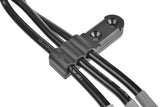 Close-up of black plastic wire holder securing three black wires, part of the Team Corally C-00180-1017 Motor Wire Holder Set for organizing RC car motor cables.