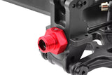 Close-up of a red Team Corally C-00180-329 Aluminum Wide Wheel Hex Adapter (2) mounted on a black RC car part, designed for radio control car wheels and durable performance.