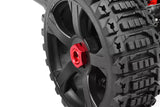 Close-up of a black rc car wheel with a red Team Corally C-00180-230 Red 17mm Aluminum Ribbed Wheel Nut (4) securing the rim, highlighting durable radio control car parts.