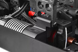 Close-up view of a black and silver Team Corally C-00180-655 Pinion Cover installed on an rc car, showcasing detailed radio control parts and motor housing components.