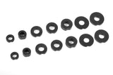 Set of black plastic shims in various sizes for precision adjustment included in the Team Corally C-00180-055 Suspension Arm Shim Kit for radio control parts.