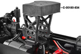 Close-up of a radio control car chassis featuring the Team Corally C-00180-716 Center Roll Cage Mount for Chassis Tube installed in black plastic with structural support elements.