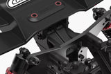 Close-up view of a black Team Corally COR00180-539 Wing Mount Connecting Brace installed on an RC car chassis, showcasing durable radio control parts for stability and performance.