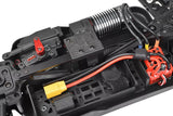 Close-up of the internal components of an rc car chassis featuring the Team Corally C-00180-1019 Aluminum 3mm Chassis Brace, motor, wiring, and electronic parts.
