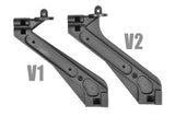 Two black plastic rear shock tower braces labeled V1 and V2 shown side by side, highlighting design differences for Team Corally C-00180-105-2 Rear Shock Tower Brace V2 Body Mount.