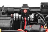 Close-up of Team Corally C-00180-660 Torox 135, 180 Switch Holder Tube 12mm installed in a radio-controlled car chassis, showing wiring and electronic components.