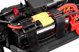 Team Corally C-00180-004-1 Battery Strap Hook & Loop (2) securing a battery in an RC car chassis with black hook and loop straps around the battery and connectors.