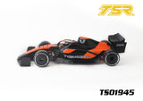 Team Saxo TS01945 1/10 F1 Body Shell (Clear) mounted on a scale 1/10 radio control car chassis in black and orange with detailed aerodynamic design and racing decals.