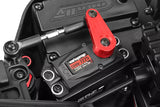 Close-up of a red Team Corally C-00180-372 Aluminum Steering Servo Arm installed on a black radio control servo motor in an RC car chassis.