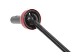 Close-up view of the Team Corally C-00180-341 CVD Drive Shaft Long Front, a precision radio control part with a black drive shaft and red metal housing for enhanced durability.