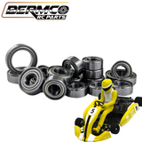 Bermco RC Parts Team Saxo GK-200 Hybrid Ceramic Bearing Kit displayed with multiple metal bearings and a yellow-suited driver figure in a small yellow and black RC go-kart.