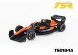 Team Saxo TS01945 1/10 F1 Body Shell (Clear) featuring a sleek black and orange design for radio control cars, ideal for customization and performance upgrades.